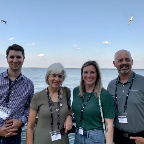 Group shot of four Solid Light team members on the Milwaukee Lakefront